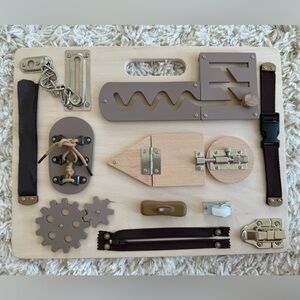 Handmade busy board. Great for developing early fine motor skills